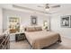 Bedroom featuring a tray ceiling, ceiling fan, and natural light with a picture of a lion at 1590 Ridgebrook Downs, Mableton, GA 30126