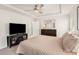 Bedroom featuring a tray ceiling, ceiling fan, and adjacent bathroom access at 1590 Ridgebrook Downs, Mableton, GA 30126