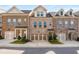 Charming brick townhome featuring a two-car garage, dormer windows, and inviting front porch at 1590 Ridgebrook Downs, Mableton, GA 30126