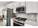 Modern kitchen featuring stainless steel appliances, light gray backsplash, and granite countertops at 1590 Ridgebrook Downs, Mableton, GA 30126