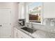 Bright kitchen nook with stainless steel sink and appliances, granite countertops, and modern finishes at 1590 Ridgebrook Downs, Mableton, GA 30126