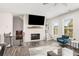 A modern living room features a fireplace, staircase, lots of light and an accent chair at 1590 Ridgebrook Downs, Mableton, GA 30126
