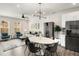 Open-concept living space features dining area, comfortable seating, and stainless steel refrigerator at 1590 Ridgebrook Downs, Mableton, GA 30126
