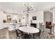 Open concept living area with modern lighting, a dining area, and an adjacent kitchen at 1590 Ridgebrook Downs, Mableton, GA 30126