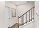 Staircase has wood stairs, a wood handrail with black balusters and white walls at 1590 Ridgebrook Downs, Mableton, GA 30126