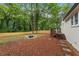 Large backyard with a fire pit, deck, and fenced perimeter at 1927 Willa Way, Decatur, GA 30032