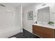 A modern bathroom with a walk-in shower, dual vanity, and patterned floor tiles at 1927 Willa Way, Decatur, GA 30032