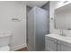 Modern bathroom with a frosted glass shower, gray vanity, and modern fixtures at 1927 Willa Way, Decatur, GA 30032