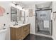 Modern bathroom featuring a double sink vanity, glass shower, and black hexagon tile at 1927 Willa Way, Decatur, GA 30032