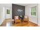Stylish bedroom seating area featuring hardwood floors, white walls, and a decorative geometric wall at 1927 Willa Way, Decatur, GA 30032