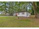 Landscaped front yard with a freshly painted exterior, new driveway, and mature trees at 1927 Willa Way, Decatur, GA 30032