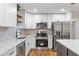 Well-lit kitchen featuring white cabinets, stainless steel appliances and light countertops at 1927 Willa Way, Decatur, GA 30032