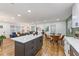 Open-concept kitchen, dining, and living area with stainless steel appliances and abundant natural light at 1927 Willa Way, Decatur, GA 30032