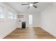 Bright living room with kitchenette and wood-look floors at 1927 Willa Way, Decatur, GA 30032