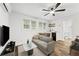 Well-lit living room with a kitchenette, ceiling fan, and wood-look flooring at 1927 Willa Way, Decatur, GA 30032