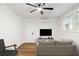Bright living room with ceiling fan, television, and wood-look flooring at 1927 Willa Way, Decatur, GA 30032