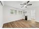 Bright living room with a kitchenette, ceiling fan, and wood-look flooring at 1927 Willa Way, Decatur, GA 30032