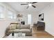 Cozy living room with kitchenette, ceiling fan, couch, and wood-look flooring at 1927 Willa Way, Decatur, GA 30032
