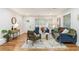 Cozy living room featuring hardwood floors, neutral wall colors, and large windows at 1927 Willa Way, Decatur, GA 30032