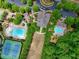 Beautiful aerial view of the community amenities, including pools, tennis courts, playground, and clubhouse at 207 Harmony Lake Dr, Canton, GA 30115