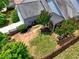 Aerial view of a house with a fenced yard, landscaping, patio, and driveway at 207 Harmony Lake Dr, Canton, GA 30115