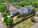 Aerial view of house with a fenced yard and mature trees in a residential neighborhood at 207 Harmony Lake Dr, Canton, GA 30115