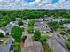 Expansive aerial view of a residential neighborhood surrounded by lush green forests and rolling hills at 207 Harmony Lake Dr, Canton, GA 30115