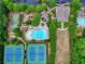 An aerial view of community amenities showcases tennis courts, a pool, and a playground for enjoyment at 207 Harmony Lake Dr, Canton, GA 30115
