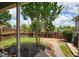 Landscaped backyard with a brick patio, mulch beds, lawn, and wood fence offers a private outdoor space at 207 Harmony Lake Dr, Canton, GA 30115