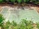 Aerial view of an outdoor basketball court surrounded by mature trees, offering a private recreational space at 207 Harmony Lake Dr, Canton, GA 30115