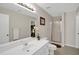 Bright bathroom featuring a white vanity, large mirror, and glass-enclosed shower at 207 Harmony Lake Dr, Canton, GA 30115