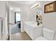 Bright bathroom features a single sink vanity and an open doorway to another room at 207 Harmony Lake Dr, Canton, GA 30115