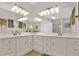 Bathroom with double vanity, white countertops, and ample lighting at 207 Harmony Lake Dr, Canton, GA 30115