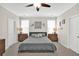 Comfortable bedroom features modern ceiling fan, neutral paint, and natural lighting at 207 Harmony Lake Dr, Canton, GA 30115