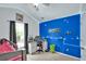 Bright bedroom featuring blue accent wall, study desk, and playful decor at 207 Harmony Lake Dr, Canton, GA 30115