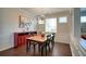 Elegant dining room with hardwood floors, stylish light fixture, and a bright window view at 207 Harmony Lake Dr, Canton, GA 30115