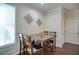 Dining room with a wooden table and four chairs, featuring wainscoting and decorative wall art at 207 Harmony Lake Dr, Canton, GA 30115