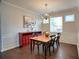 Bright dining area with hardwood floors, a large window, and classic wainscoting at 207 Harmony Lake Dr, Canton, GA 30115