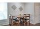 Dining room features a wooden table and seating for four, accented by decorative wall art and natural light at 207 Harmony Lake Dr, Canton, GA 30115