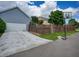 Exterior view featuring a driveway, garage, and basketball hoop, in a residential area at 207 Harmony Lake Dr, Canton, GA 30115