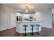 Updated kitchen features breakfast bar with seating, stainless appliances, and stylish pendant lighting at 207 Harmony Lake Dr, Canton, GA 30115