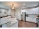 Bright, open kitchen with white cabinetry, granite countertops, stainless steel appliances and bar seating at 207 Harmony Lake Dr, Canton, GA 30115