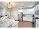 Bright kitchen features stainless steel appliances, white cabinets, granite counters and hardwood floors at 207 Harmony Lake Dr, Canton, GA 30115