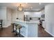 Bright kitchen featuring white cabinets, stainless steel appliances, and a large island with counter seating at 207 Harmony Lake Dr, Canton, GA 30115