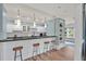 Charming kitchenette features a breakfast bar with seating, white cabinets, and bright lighting at 207 Harmony Lake Dr, Canton, GA 30115