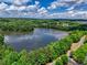 A stunning lake view framed by lush trees and a partly cloudy sky provides a picturesque backdrop at 207 Harmony Lake Dr, Canton, GA 30115