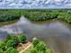 A serene lake view with a dock and boat house surrounded by lush greenery enhances this community's appeal at 207 Harmony Lake Dr, Canton, GA 30115