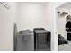 Laundry room featuring front load washer/dryer and storage shelving at 207 Harmony Lake Dr, Canton, GA 30115