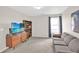 Living room with TV, sofa, bookshelf, and natural light at 207 Harmony Lake Dr, Canton, GA 30115