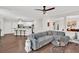 Open-concept living room with a large sectional sofa and view to kitchen, creating a comfortable and inviting space at 207 Harmony Lake Dr, Canton, GA 30115